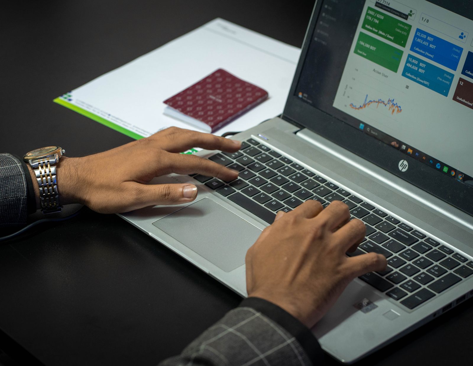Businessman analyzing data on laptop screen in office