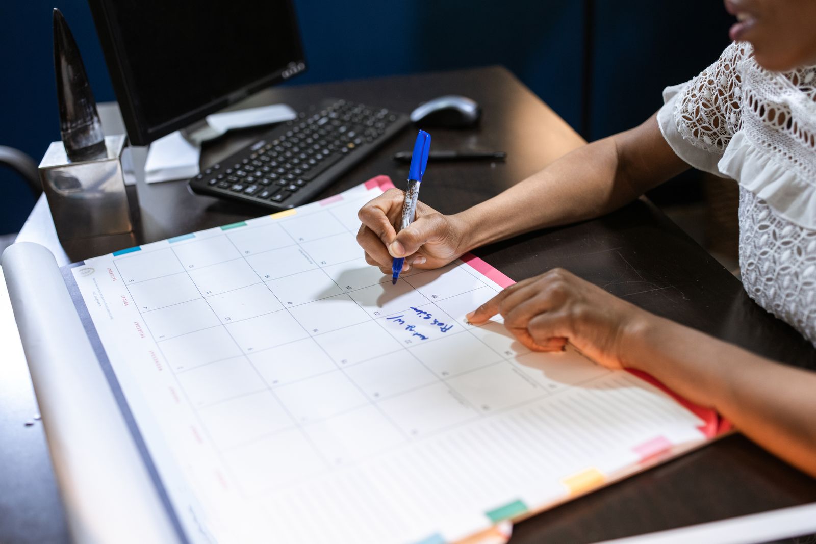 A person writing on calendar