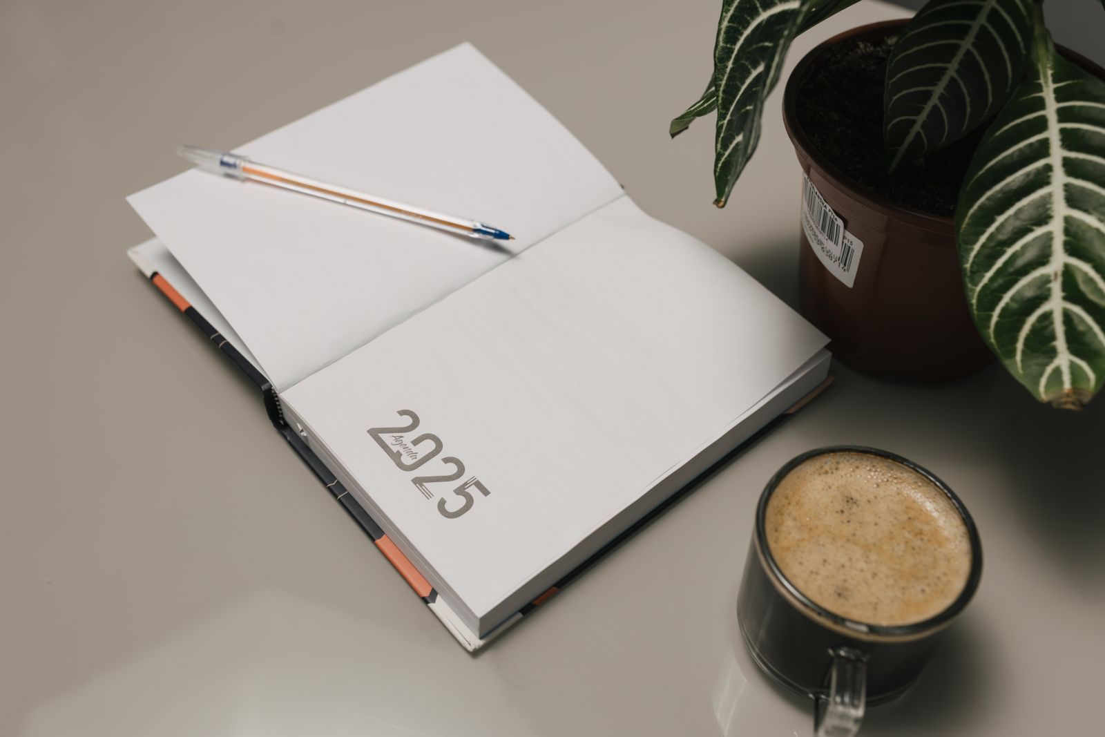 Minimalist desk setup with journal and coffee
