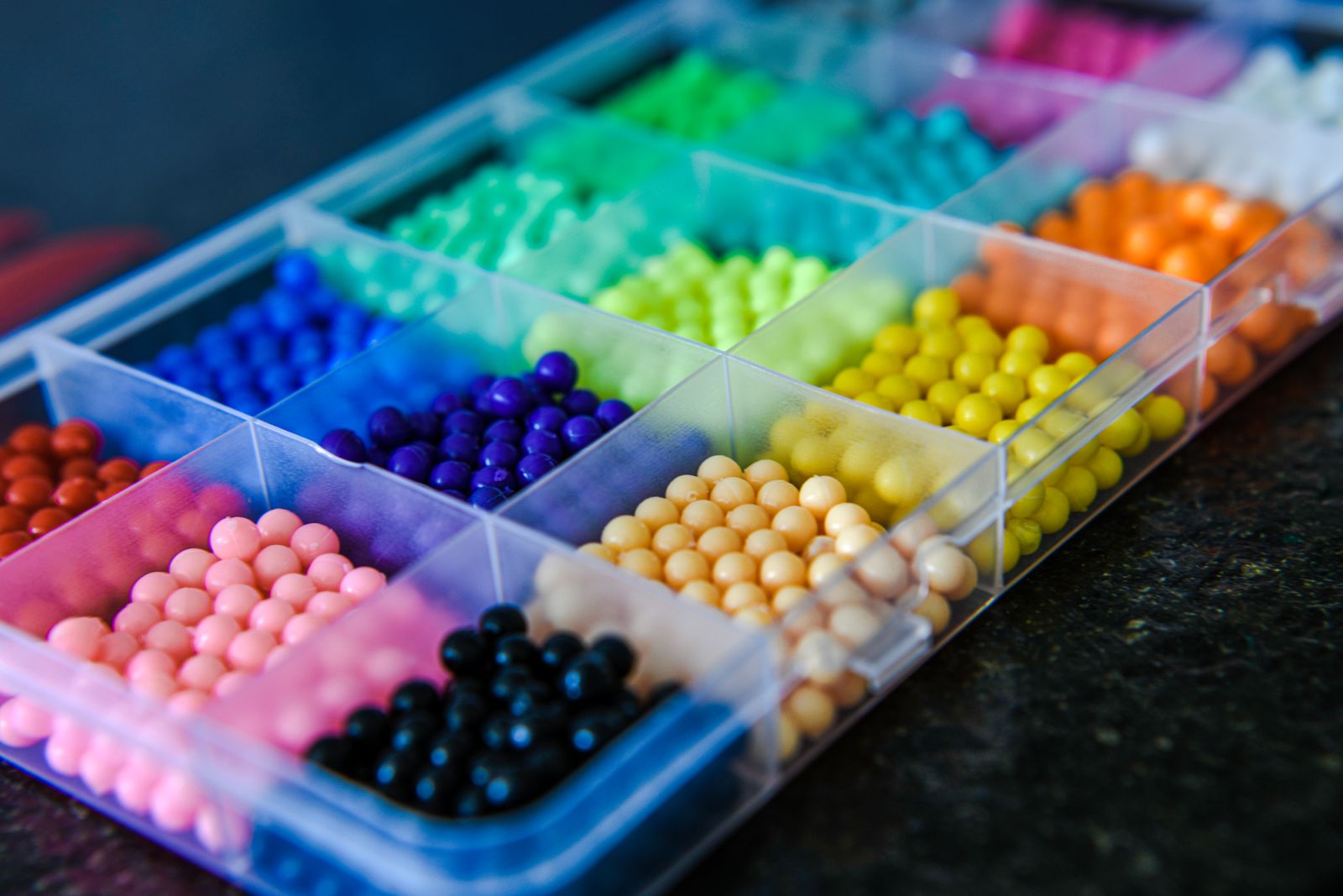 Sorted colorful balls in plastic box