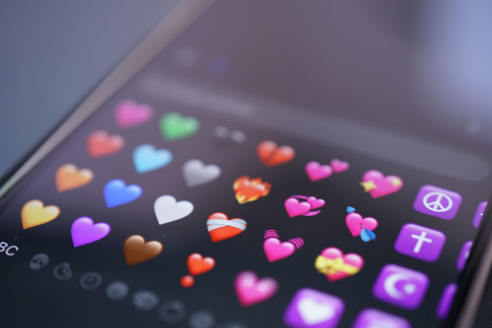 Colorful heart emojis on smartphone screen