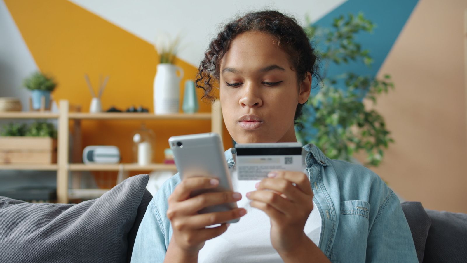 Woman shopping online with smartphone and card