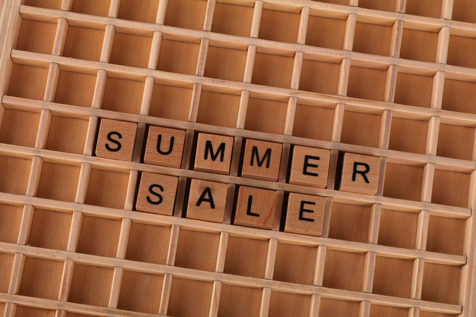 Wooden block letters spelling summer sale